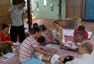 Teacher shows Chi Nei Tsang technique to students in Chiang Mai